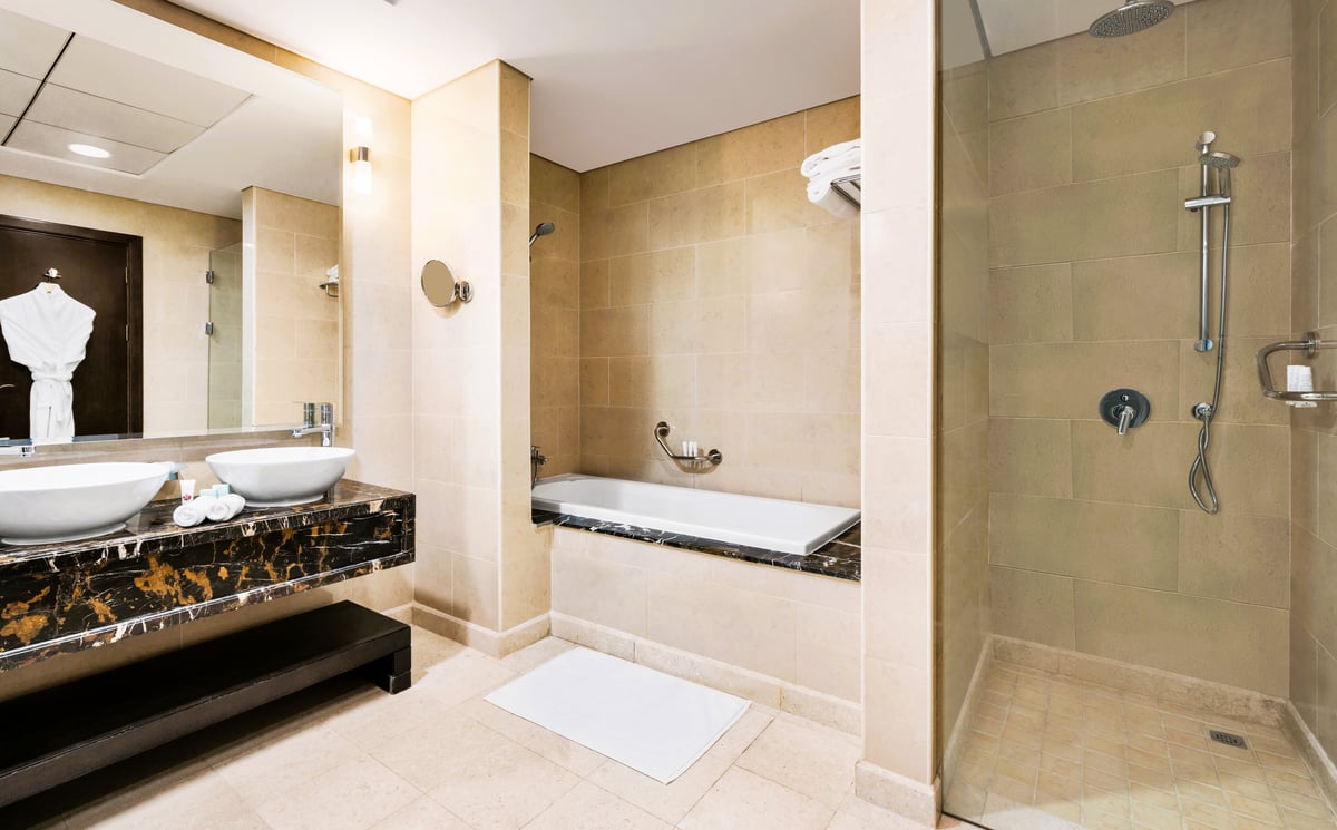 Hotel Dubai United Arab Emirates nomad remote 61de298e-1de3-4e32-84d1-86117cc55524_Bathroomwithbathtubandwalkinshowera.jpg